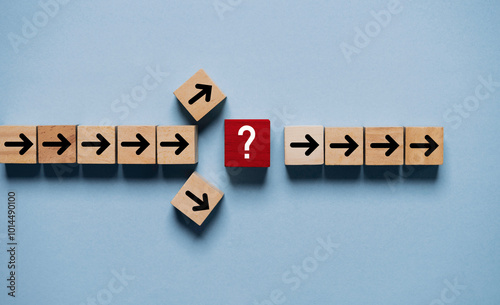 Question mark print screen on red wooden block cross in the middle of arrow for interrupt of process concept.