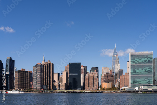 Manhattan skyline featuring iconic skyscrapers and waterfront on a clear day.