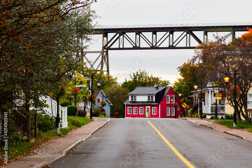 The Provancher street in the old part of the Cap-Rouge neighbourhood, with the 1908 railway trestle bridge seen during a cloudy fall morning in the background, Quebec City, Quebec, Canada