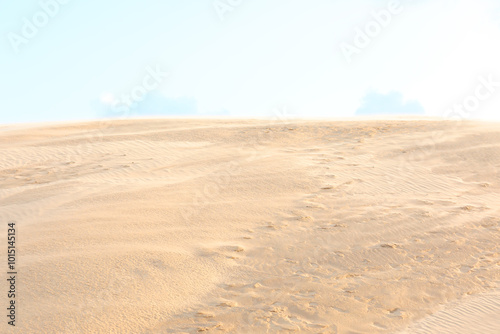 wind whipping sand from the sandy desert dunes