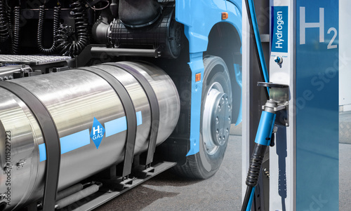 A hydrogen fuel cell semi truck with H2 gas cylinder onboard next to filling station. Eco-friendly commercial vehicle concept.