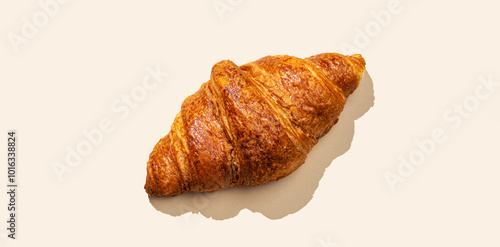 Fresh croissants on yellow background with shadow. Creative layout and concept of healthy food and french breakfast.