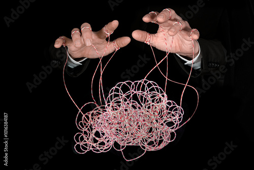 Hands pulling tangled strings. Concept of emotional manipulation, mental health, world conspiracy theories, control and dictatorship