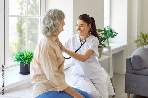 Young woman nurse or doctor stethoscope examining old senior patient, GP checking heartbeat at hospital checkup medical visit at clinic, older people cardiology healthcare, appointment for grandma