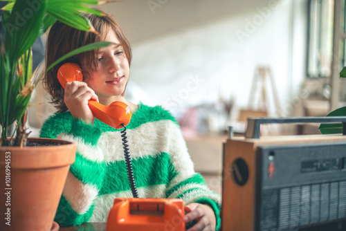 retro, cute girl teen talking on old orange vintage phone with dialer