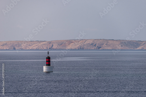 Black and red buoy on the Adriatic Sea as warning and navigation sign