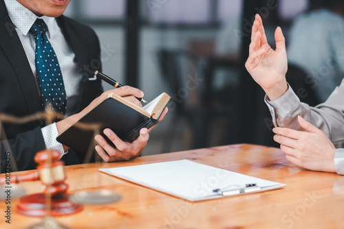 Professional lawyer consulting with a client, discussing legal documents and providing advice in a modern office setting.