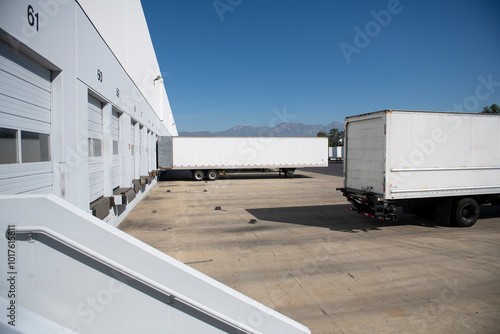 White box truck trailer backing into distribution warehouse bay