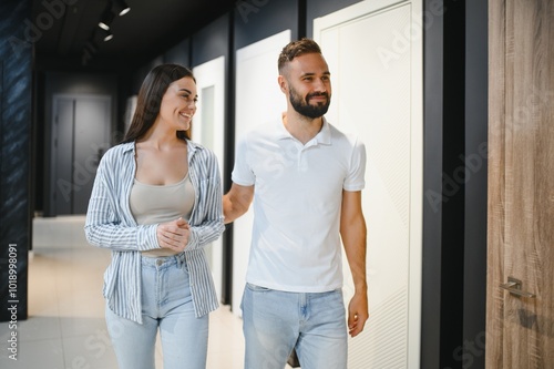 A young couple chooses interior doors for their new home.