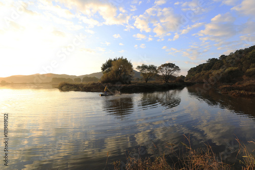 Early in the morning a fisherman on Upo Wetland, Changnyeong-gun, Gyeongsangnam-do, Korea - October 19, 2019: The largest natural swamp in Korea. In 1997 it was designated as an RAMSAR wetland.