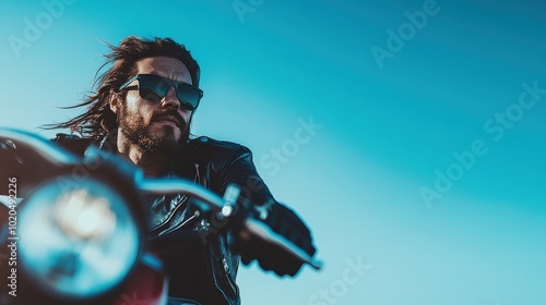 A rugged man rides a motorcycle, exuding a sense of freedom and adventure against a clear blue sky, capturing the essence of a rebellious spirit.