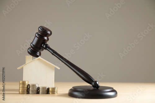 Judge auctions and the real estate legal system House model and gavel with icons on a wooden table Laws governing foreclosures and bankruptcies, debts or liens, divorces, inheritances