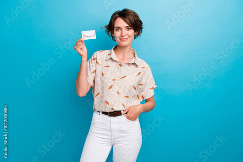 Photo of stunning lady put hand pocket hold demonstrate plastic debit card isolated on blue color background