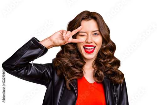 Close up photo of curly lady with amazing red lipstick showing v-sign near winking eye wear leather jacket isolated yellow background