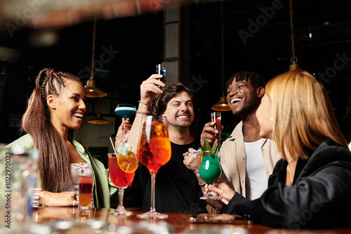 A group of diverse colleagues shares laughter and cocktails at a trendy corporate gathering.