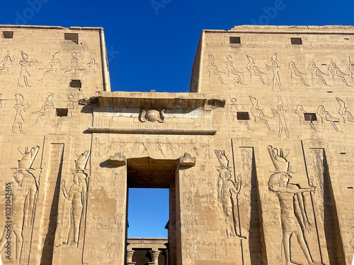 Pass through the sacred gate of the Temple of Horus at Edfu, where ancient Egyptian mythology comes to life in the intricate carvings and hieroglyphics of ancient Egypt.