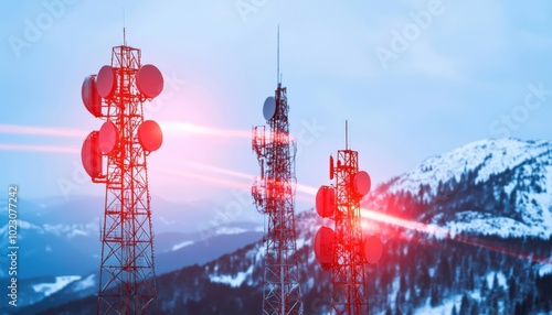 Telecommunication Towers on Snowy Mountain Peak with Red Lens Flare