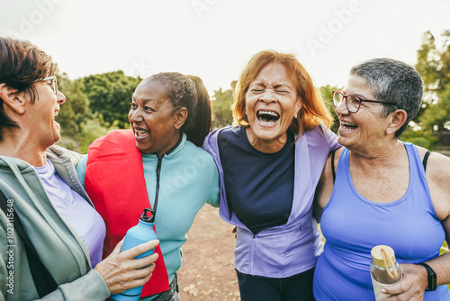 Multiracial senior women having fun together after yoga class outdoor - Healthy lifestye and mature people concept - Main focus on center latin female face