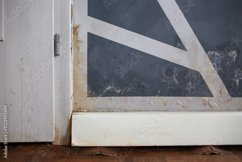 consequences of flooding in the apartment: swollen floor and moldy wall. needs renovation