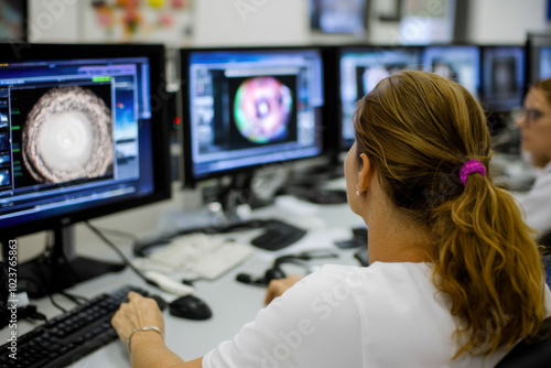 Meteorologist team monitoring weather forecast at monitor screen in meteorological office workplace. Woman meteorologist monitors formation of dangerous storms, approaching catastrophic hurricane