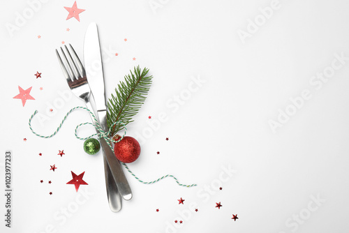 Christmas table setting. Cutlery and festive decor on white background, top view. Space for text