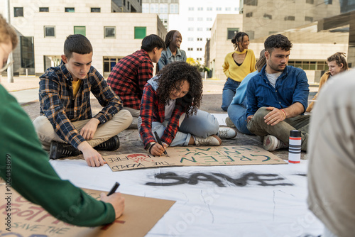 Diverse student activists prepare protest signs: youth engagement in social change