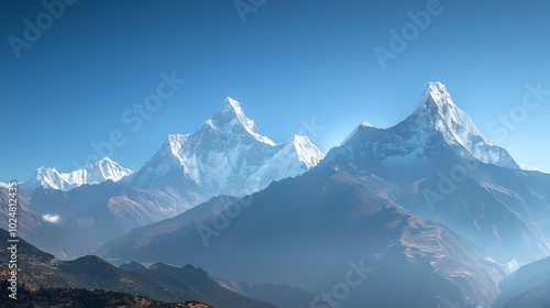 Snow-capped mountains against a clear blue sky.