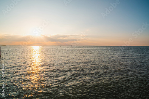 Cloudy sunset. View from the coast towards sea. Italy.