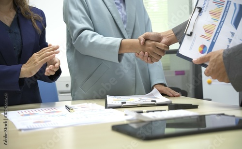 Group of business people discussing work and agreeing to work together. Business people discussing projects in office using laptops. Business people shaking hands in conference room. Video.