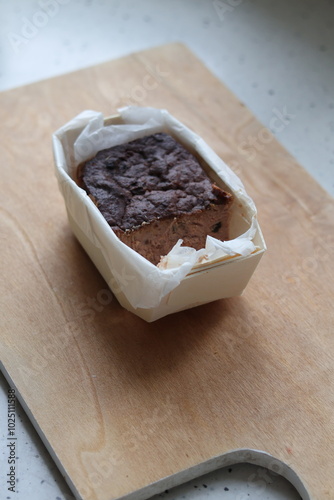 A minimalist photo of homemade pork pate with cranberries in a small tin