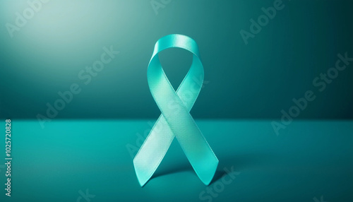 Teal ribbon symbolizing ovarian and cervical cancer awareness on a teal background. 