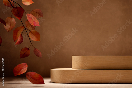 Natural wood podium and autumn leaves on brown table background. Fall season and thanksgiving mockup template for luxury product placement. Neutral aesthetic scene showroom.