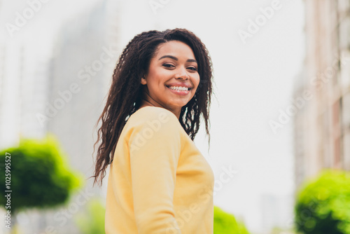 Photo of positive cheerful lovely girl wear yellow stylish clothes walk megapolis white light day outdoors