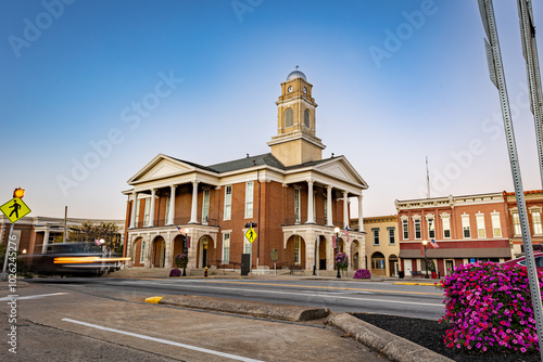 Morning traffic headlights illuminate the downtown square in Lancaster, Kentucky, with the historic courthouse as a backdrop in this small American town.