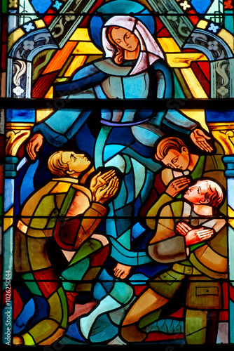 2024-08-01, Paris, FRANCE. Stained glass of the Virgin Mary protecting soldiers. .