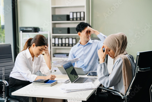 Furious two Asian businesspeople arguing strongly after making a mistake at work