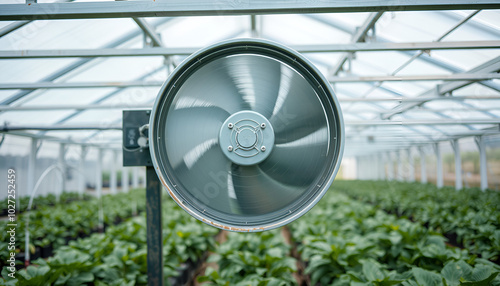 Agriculture: Greenhouse fan whirrs at full speed to pull air from inside the large unit and maintain an optimum temperature.