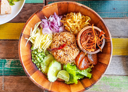 khao kluk kapi or shrimp paste fried rice more ingredient slice cow pea and sour mango cooking with sausage. mixed red onion and fried shrimp. thailand street food sweet pork sauce yummy omelet egg