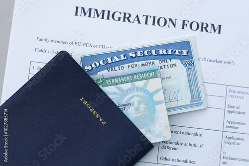 United States passport, social security card and permanent resident (green) card on immigration form. Application to register permanent residence.