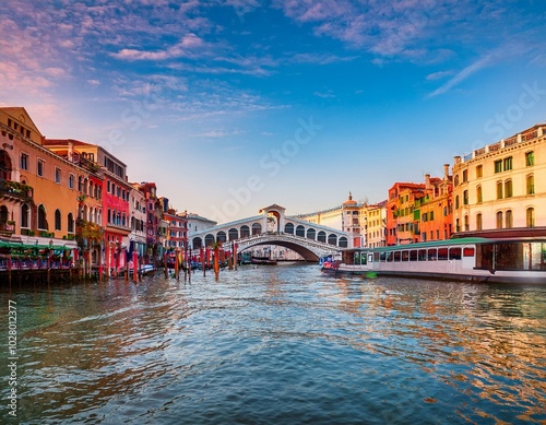 picturesque morning cityscape of venice with famous canal grande and colorful view of rialto bridge