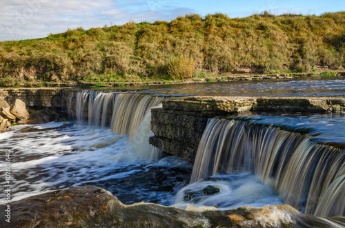 Tosnensky (Chernovsky) waterfall on a sunny October day. The widest waterfall in the Leningrad region