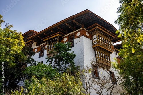 Punakha Dzong Fortress with prayer wheels, surrounded by greenery