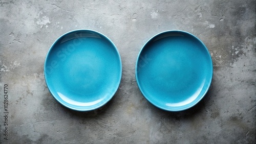 Pair of empty blue oblong plates on concrete background above Worm's Eye View