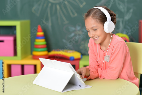 Cute little woman with tablet and headphones