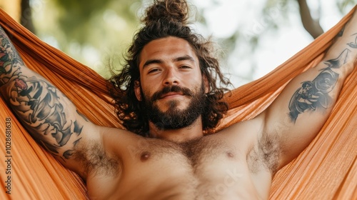 A laid-back image of a tattooed man lounging in a vibrant orange hammock, surrounded by nature. This scene captures relaxation, style, and human connection.