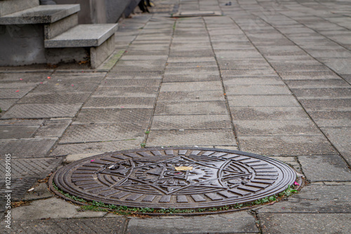 old antique cover, manhole manhole in the city on the sidewalk.