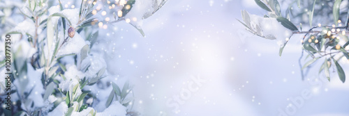 Olive branches in snow with bright bokeh lights. Horizontal background with atmospheric winter landscape for christmas greeting cards with space for text.