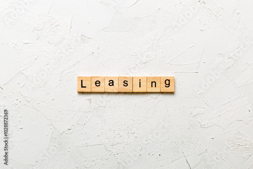 leasing word written on wood block. leasing text on table, concept