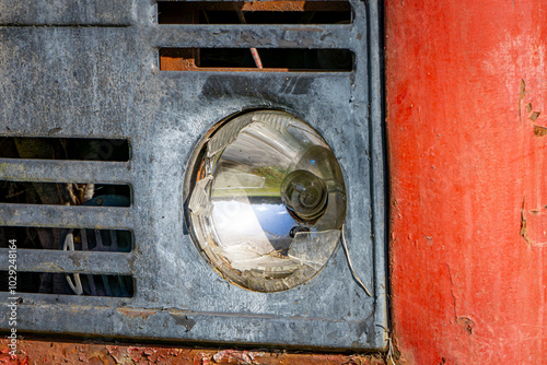 broken glass lamp in an old red car