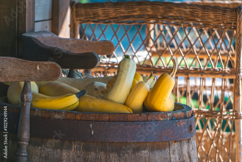 different varieties of pumpkins lying on a wooden barrel.